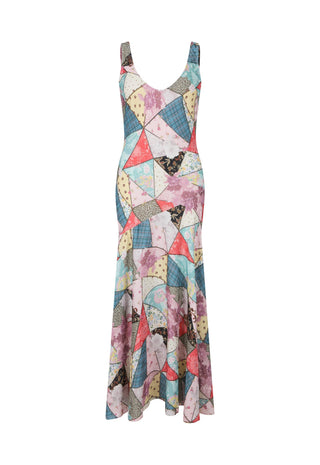 a-sleeveless-v-neck-maxi-dress-featuring-a-colorful-geometric-patchwork-print-with-triangles-and-abstract-shapes-in-pink-blue-yellow-beige-and-black-shown-against-a-plain-white-background