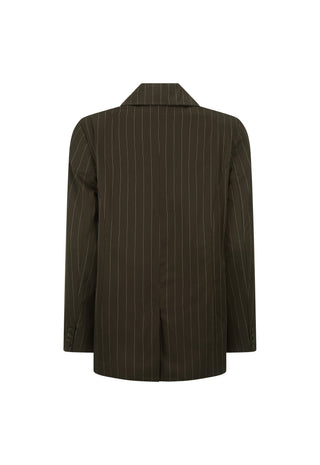A woman modeling an oversized dark brown pinstripe blazer over a matching brown lace-up top and shorts