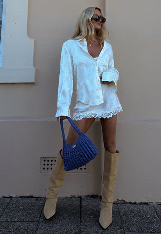 model-wearing-dubois-bias-mini-skirt-in-pearl-front-view-showing-lace-trim-hem-and-elastic-waist