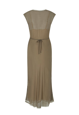 A close-up lifestyle shot of a model wearing a brown semi-sheer draped dress with a deep V-neckline and layered silver necklaces.