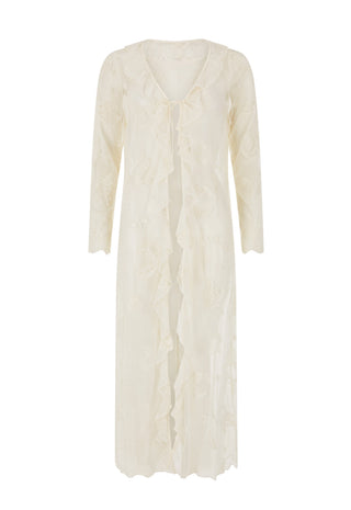  wearing a sheer white lace longline cardigan over a white lace camisole top and blue jeans