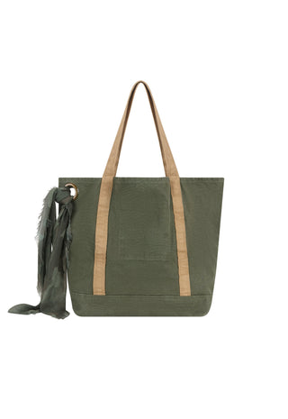 an-olive-green-canvas-tote-bag-with-tan-webbed-shoulder-straps-and-a-matching-dark-green-fringed-scarf-hanging-from-a-metal-ring-on-the-side-shown-against-a-plain-white-background