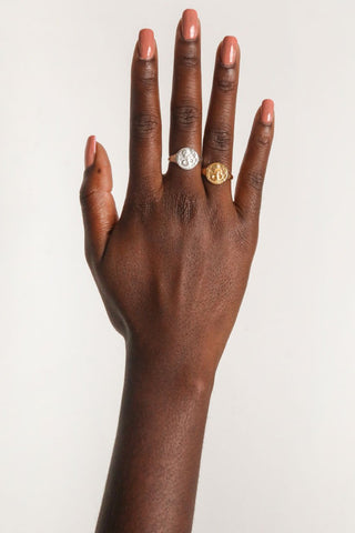 close-up-image-of-a-hand-with-painted-nails-wearing-rings-including-that-of-the-spell-s-silver-stargazer-zodiac-ring