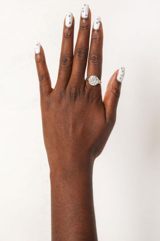 close-up-image-of-a-hand-with-painted-nails-wearing-rings-including-that-of-the-spell-s-silver-stargazer-zodiac-ring