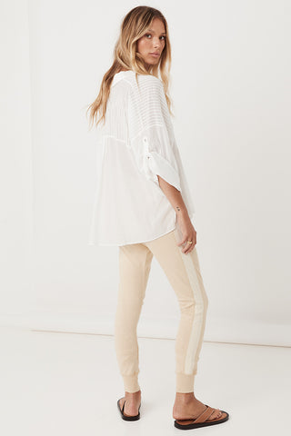 studio-model-lea-mohr-wearing-the-spell-maverick-racer-stripe-trackpants-the-pants-come-in-a-stone-colourway-and-feature-a-waistband-with-drawstring-and-a-contrast-stripe-down-the-outer-leg