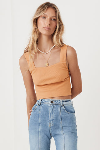 an-image-of-studio-model-lea-mohr-wearing-the-mazzy-ribbed-top-the-top-comes-in-an-almond-colourway-and-features-a-square-neckline-and-thick-straps