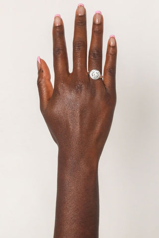 close-up-image-of-a-hand-with-painted-nails-wearing-rings-including-that-of-the-spell-s-silver-stargazer-zodiac-ring
