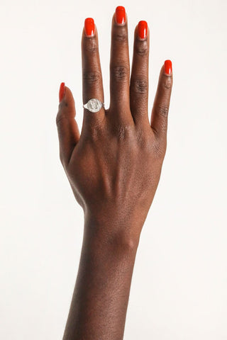 close-up-image-of-a-hand-with-painted-nails-wearing-rings-including-that-of-the-spell-s-silver-stargazer-zodiac-ring
